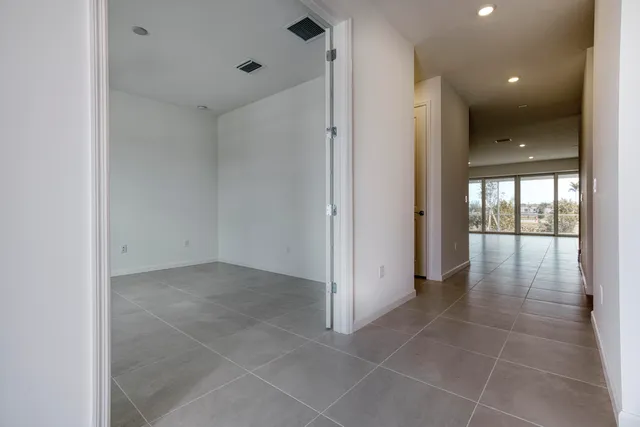 an empty room with closet and a window