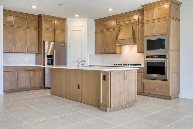 a kitchen with stainless steel appliances a sink stove and refrigerator