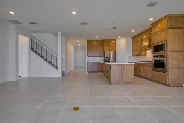 a view of kitchen with stainless steel appliances a refrigerator and a stove top oven