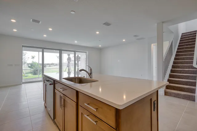 a kitchen with a sink and large window