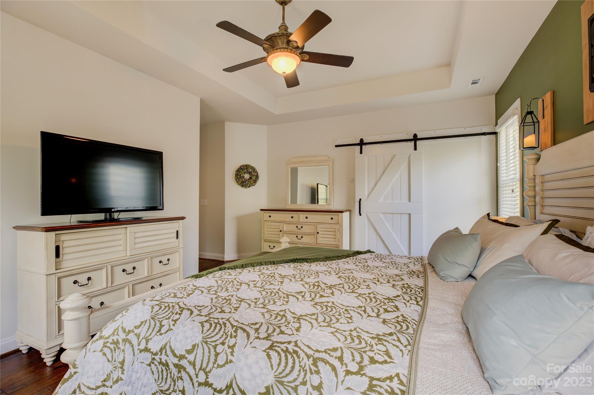 7124 Michael Scott Crossing Fort Mill, SC 29708 - Photo 26 of 48 a bedroom with a bed and a flat screen tv