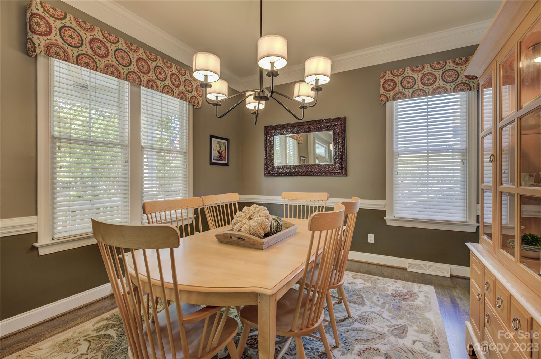 7124 Michael Scott Crossing Fort Mill, SC 29708 - Photo 9 of 48 a dining room with wooden floor a chandelier a wooden table and chairs
