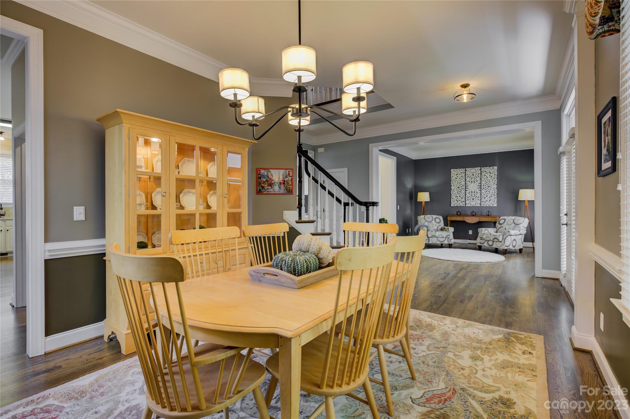 7124 Michael Scott Crossing Fort Mill, SC 29708 - Photo 10 of 48 a view of a dining room with furniture a chandelier and wooden floor