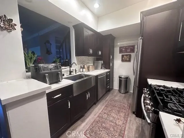 a kitchen with sink stove and cabinets