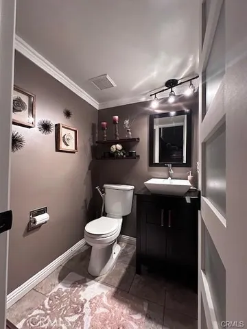a bathroom with a sink toilet and a mirror