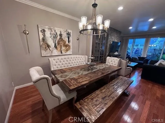 a living room with furniture a chandelier and a rug