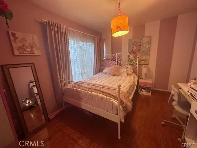 a bedroom with a bed and a mirror