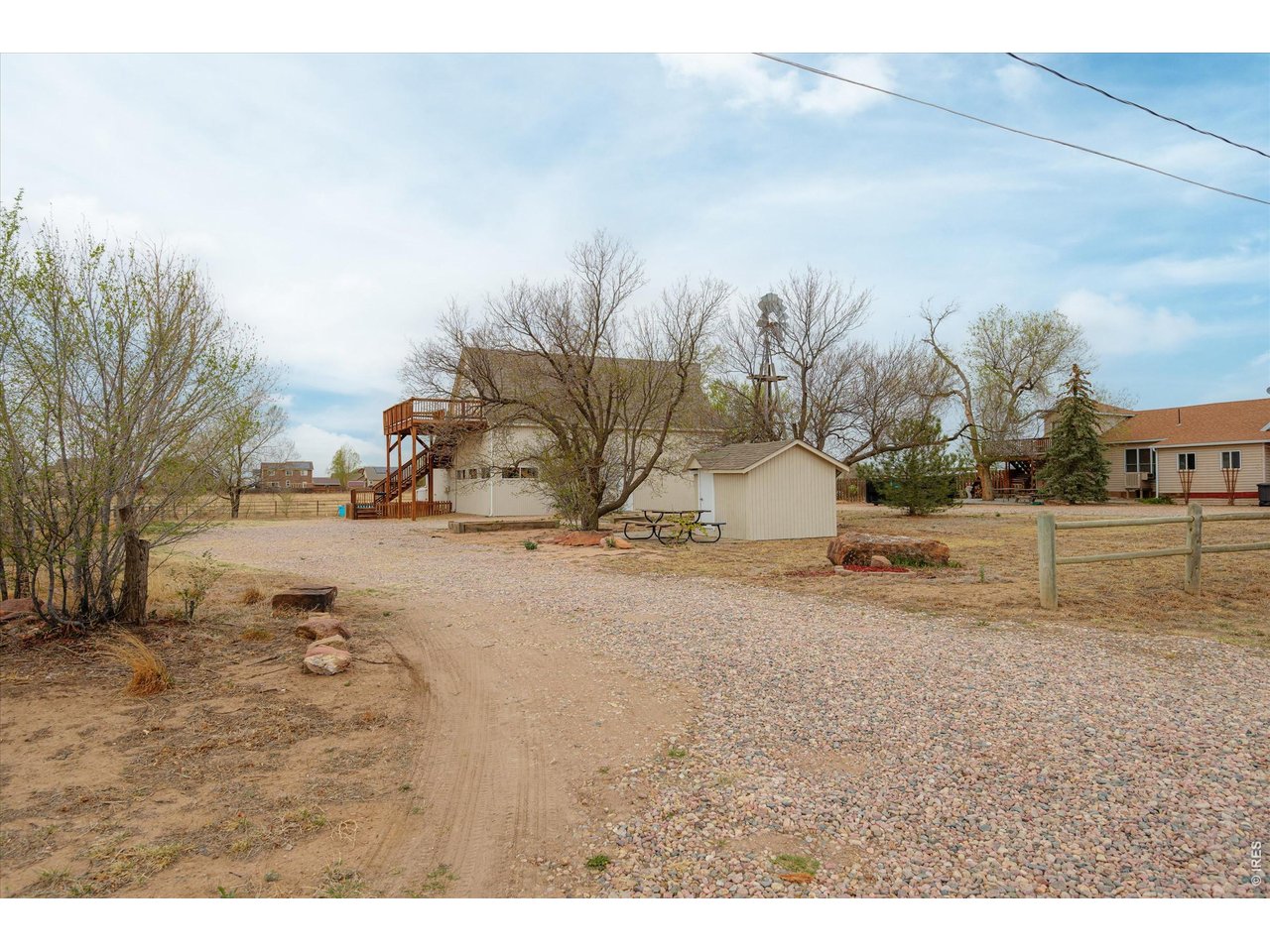 1019 3rd Street Pierce, CO 80650 - Photo 2 of 37 a view of a dry yard with wooden fence