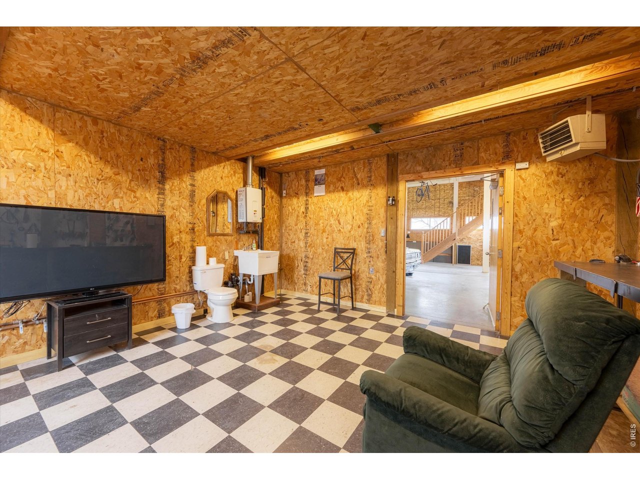 1019 3rd Street Pierce, CO 80650 - Photo 21 of 37 a living room with a couch and a flat screen tv