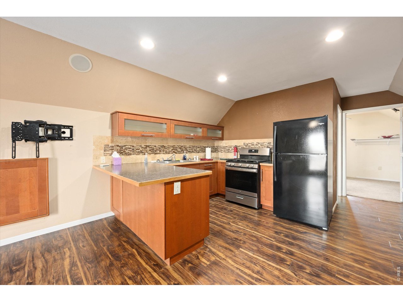 1019 3rd Street Pierce, CO 80650 - Photo 24 of 37 a kitchen with stainless steel appliances granite countertop a stove a refrigerator and a sink