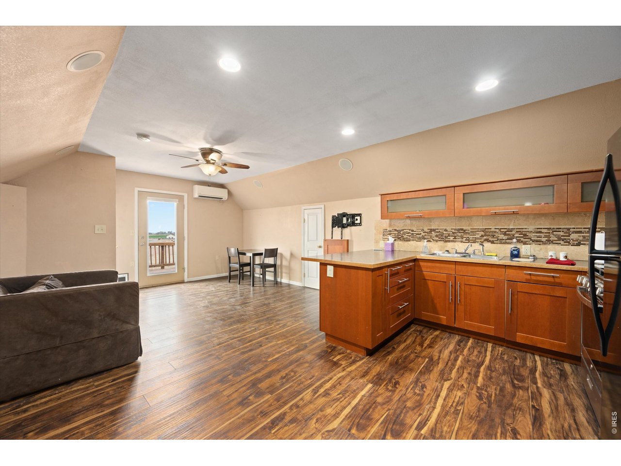 1019 3rd Street Pierce, CO 80650 - Photo 27 of 37 a kitchen with stainless steel appliances granite countertop a refrigerator a sink dishwasher a stove with wooden floor