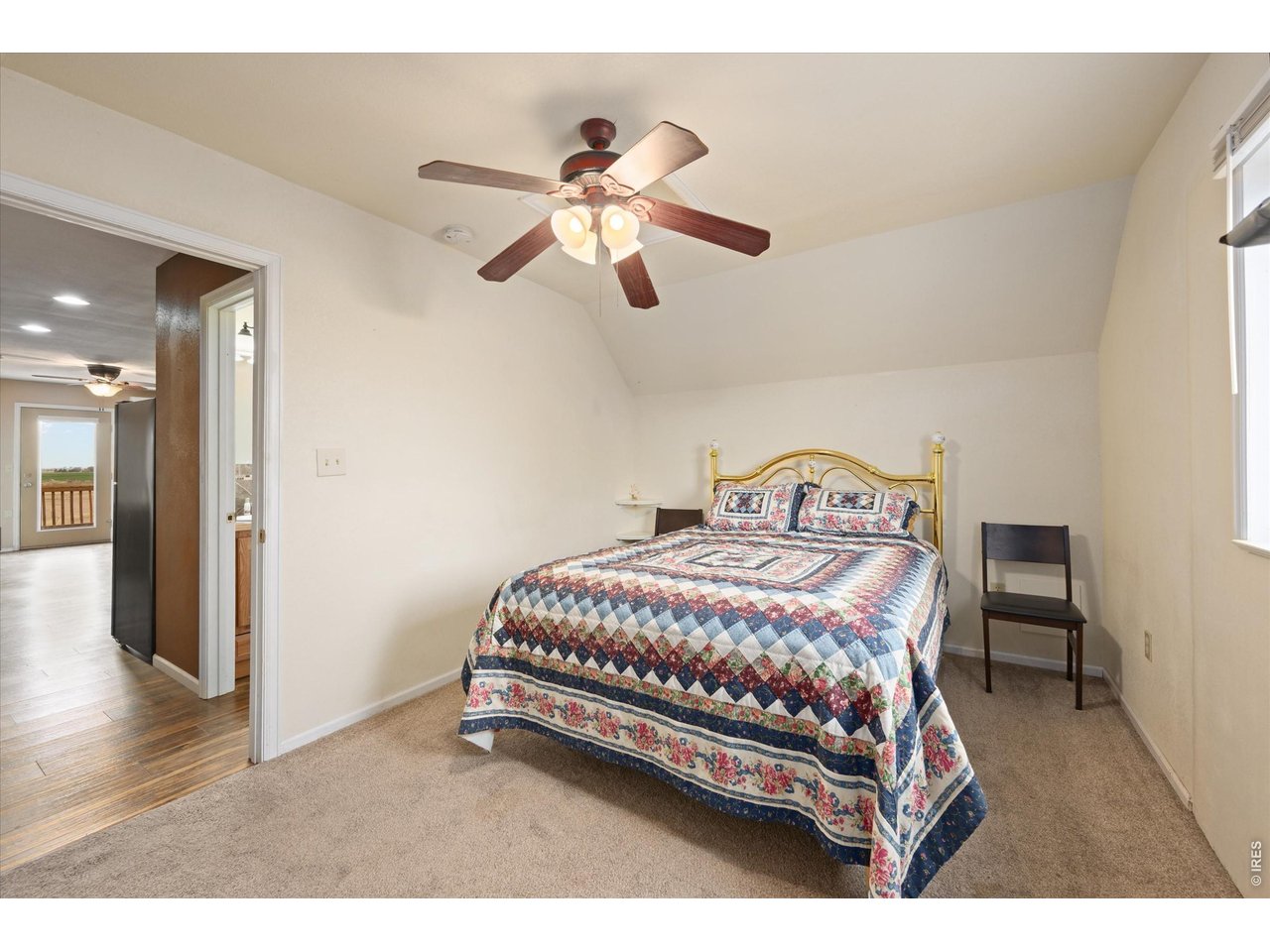 1019 3rd Street Pierce, CO 80650 - Photo 32 of 37 a bedroom with a bed and a chandelier