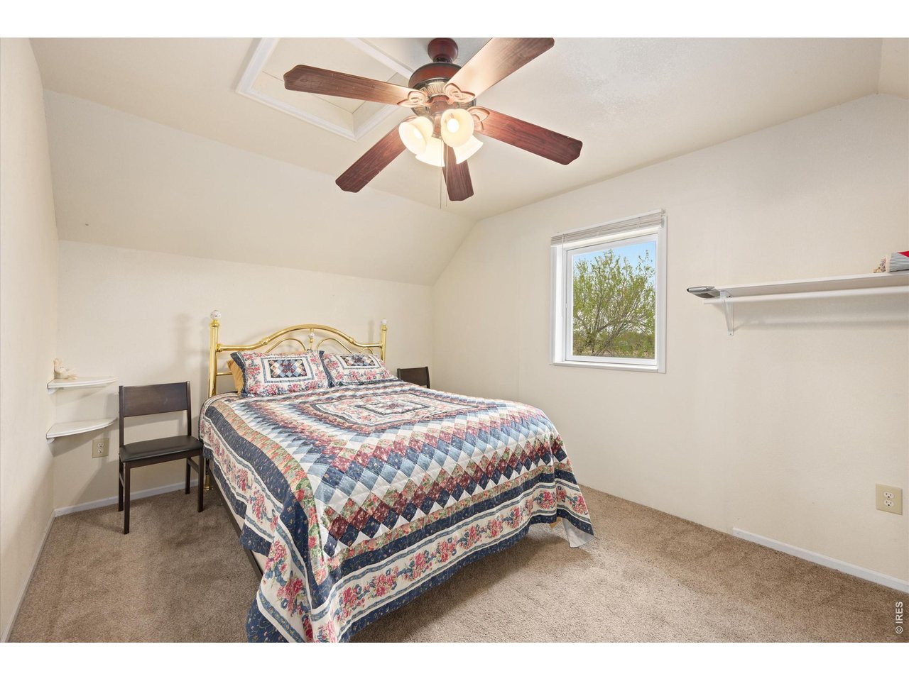 1019 3rd Street Pierce, CO 80650 - Photo 33 of 37 a bedroom with a bed and a chandelier