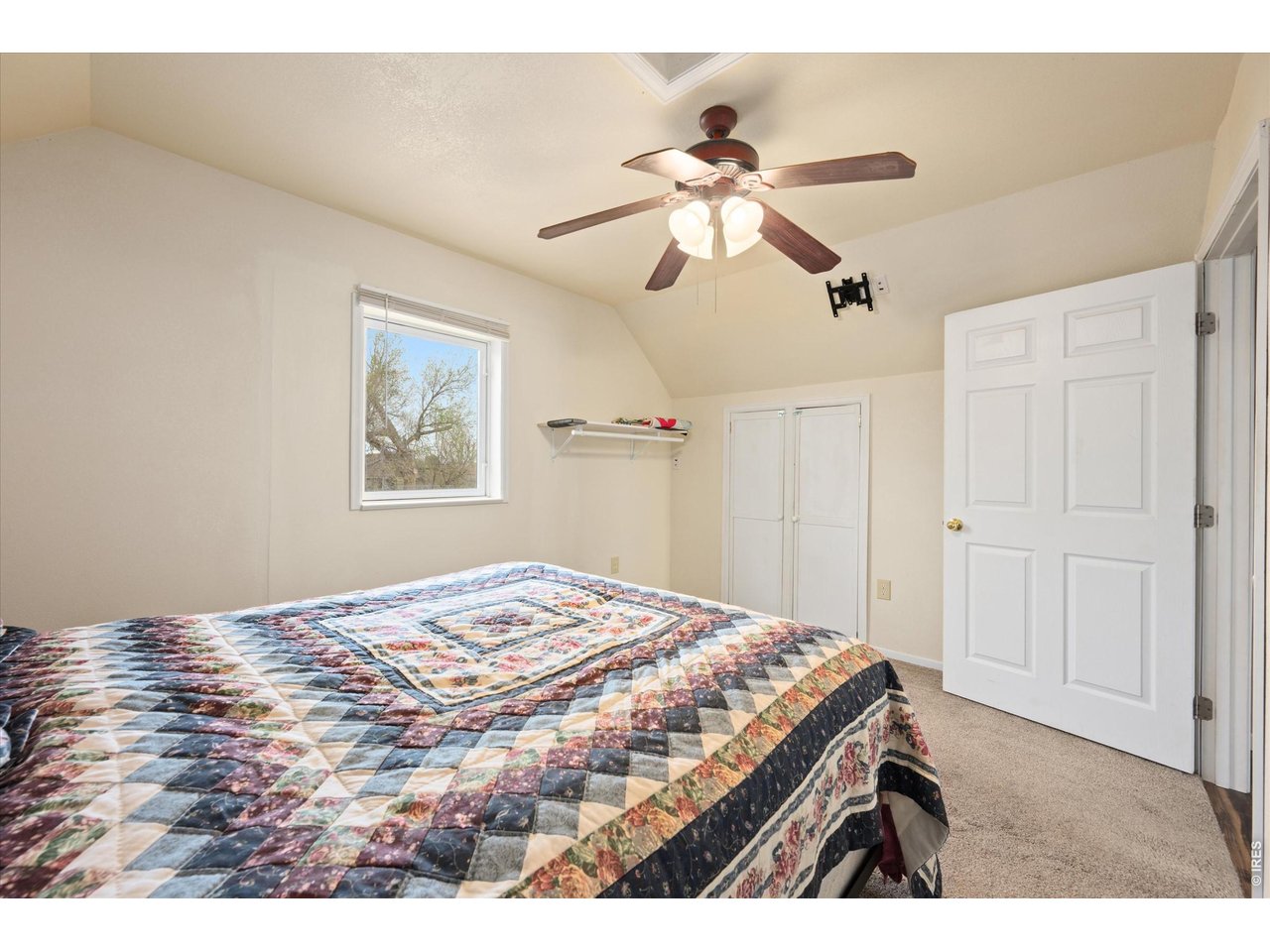 1019 3rd Street Pierce, CO 80650 - Photo 34 of 37 a bedroom with a bed and a chandelier