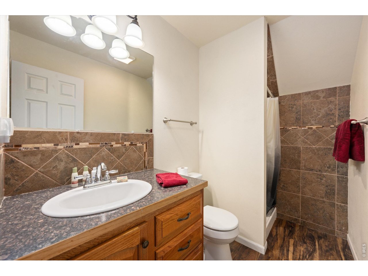 1019 3rd Street Pierce, CO 80650 - Photo 36 of 37 a bathroom with a sink vanity mirror and toilet