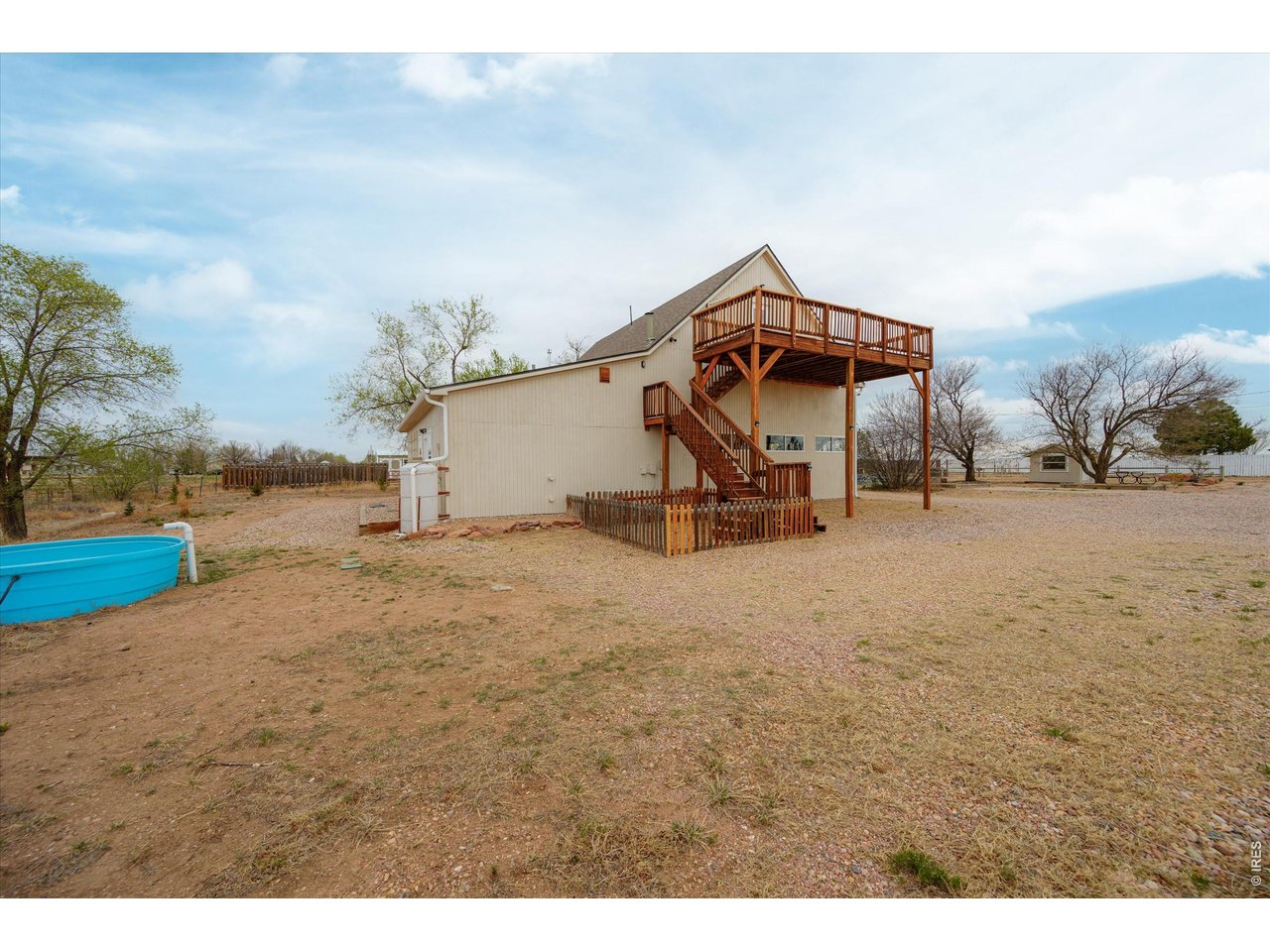 1019 3rd Street Pierce, CO 80650 - Photo 6 of 37 a house with trees in the background