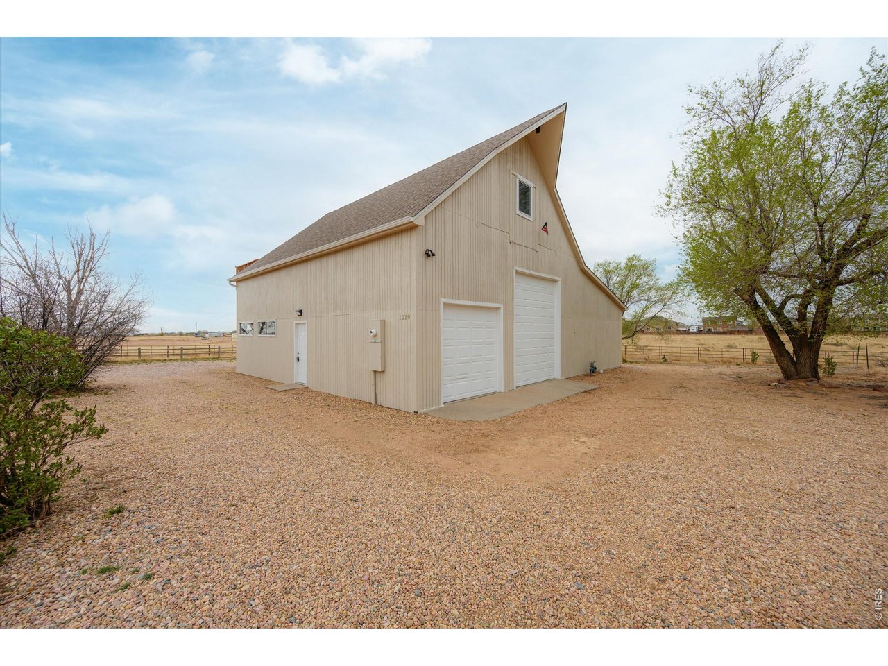 1019 3rd Street Pierce, CO 80650 - Photo 9 of 37 a view of a house with backyard and trees