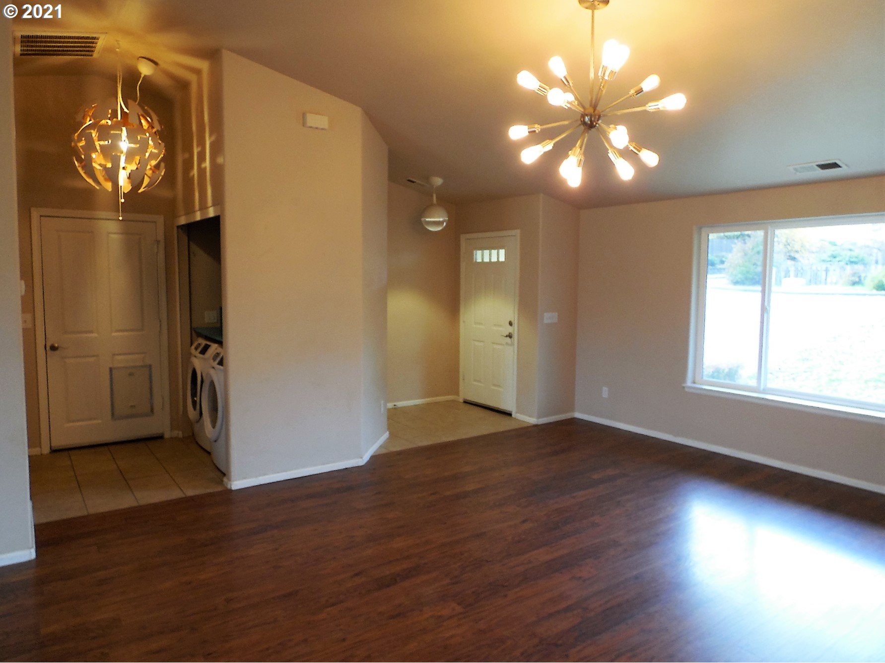 185 Lebleu Lane Winston, OR 97496 - Photo 4 of 23 an empty room with wooden floor and windows