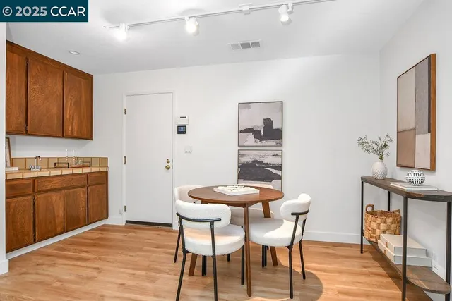 a view of a kitchen with a dining table and chairs