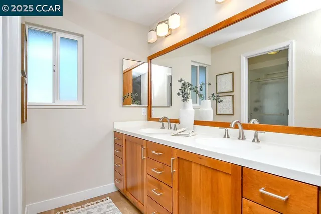 a bathroom with a sink a mirror and a shower