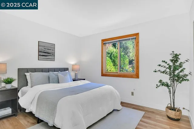 a bedroom with a bed and a potted plant