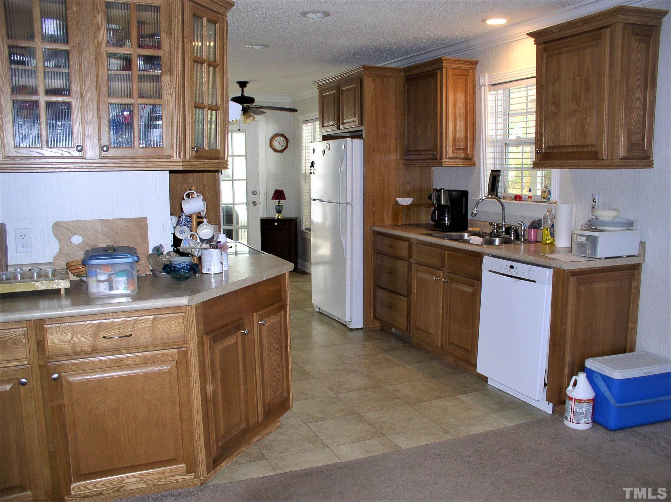 64 Fish Trail Bracey, VA 23919 - Photo 12 of 39 a kitchen with stainless steel appliances granite countertop a sink stove and refrigerator