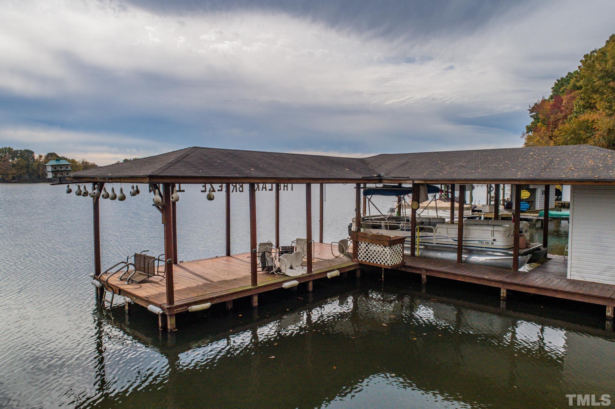64 Fish Trail Bracey, VA 23919 - Photo 2 of 39 a view of a lake with a deck