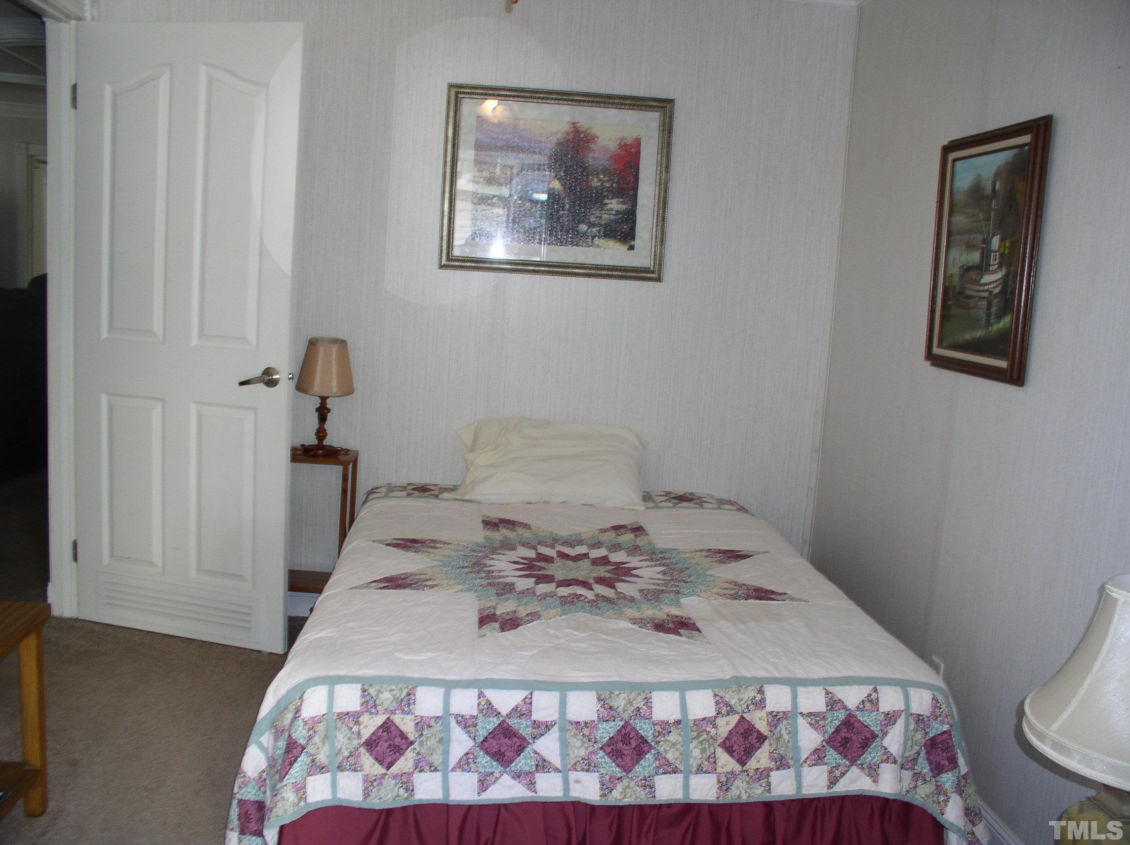 64 Fish Trail Bracey, VA 23919 - Photo 22 of 39 a bedroom with a bed and a painting on the wall