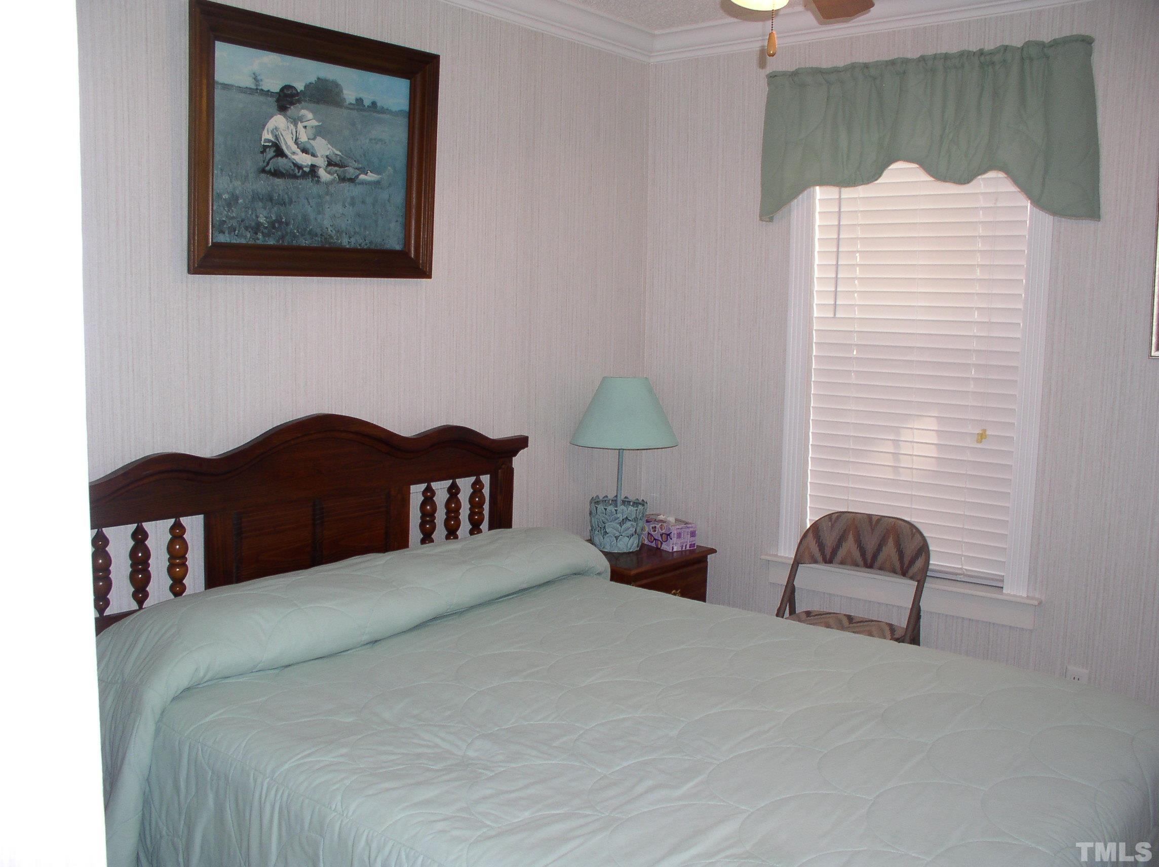 64 Fish Trail Bracey, VA 23919 - Photo 25 of 39 a bedroom with a bed and a chair