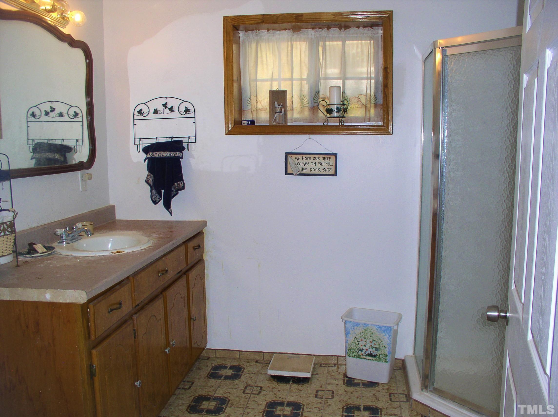 64 Fish Trail Bracey, VA 23919 - Photo 32 of 39 a bathroom with a sink and a mirror