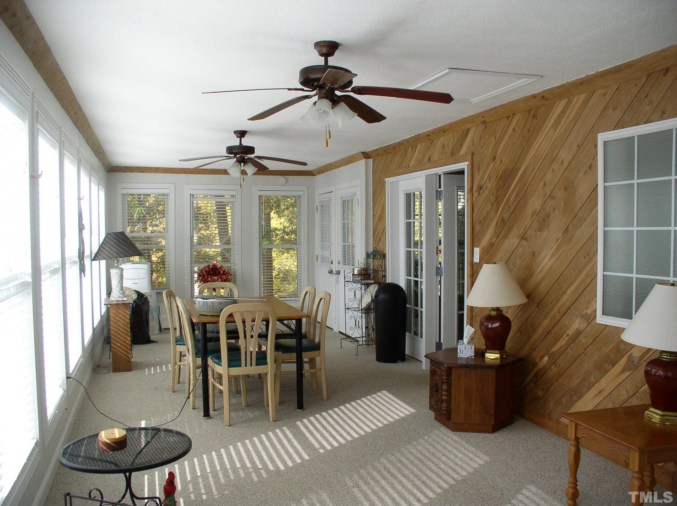 64 Fish Trail Bracey, VA 23919 - Photo 8 of 39 a living room with furniture a fireplace and a chandelier
