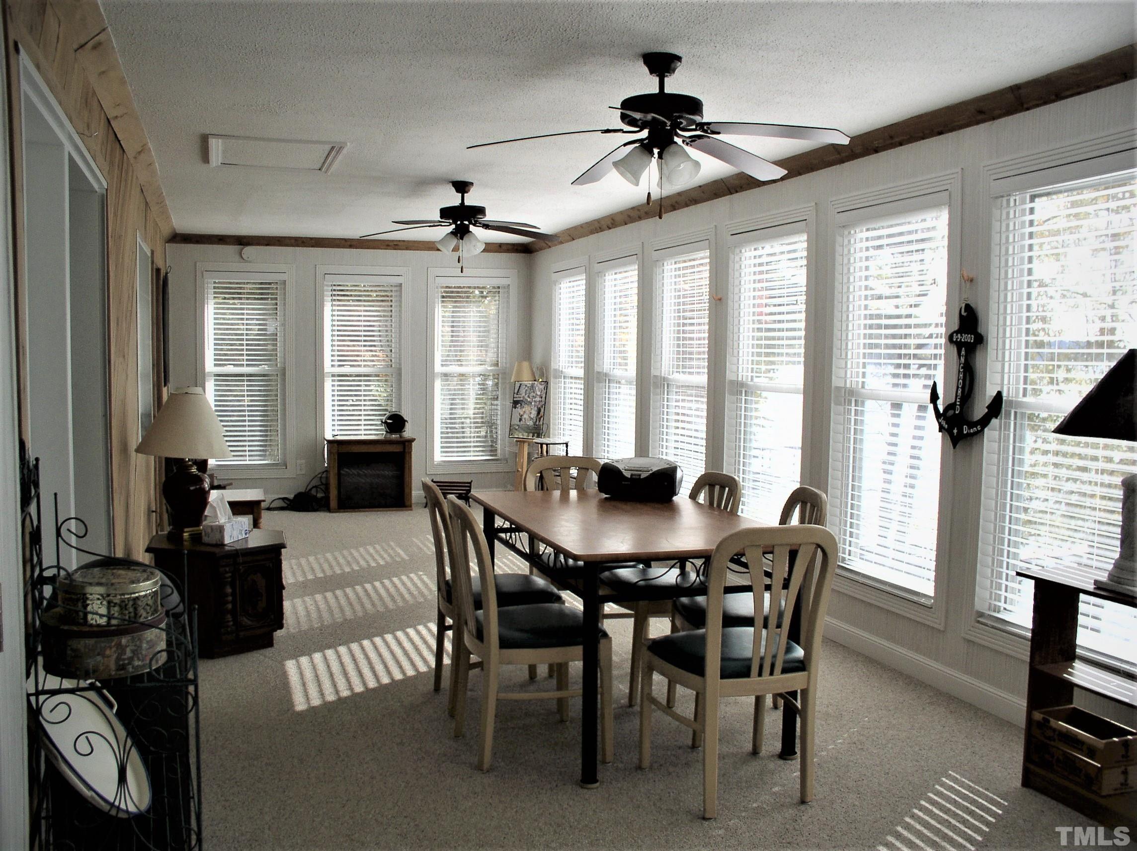 64 Fish Trail Bracey, VA 23919 - Photo 9 of 39 a view of a dining room with furniture window and outside view
