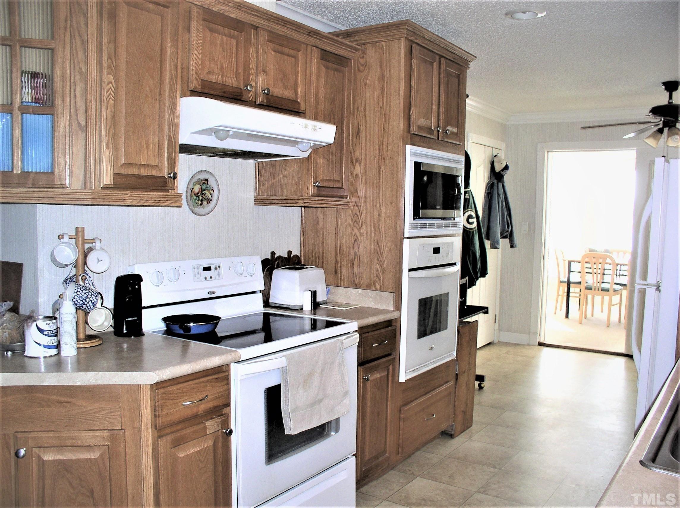 64 Fish Trail Bracey, VA 23919 - Photo 10 of 39 a kitchen with stainless steel appliances a stove microwave and sink