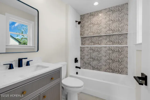 a bathroom with a sink a toilet and a bathtub