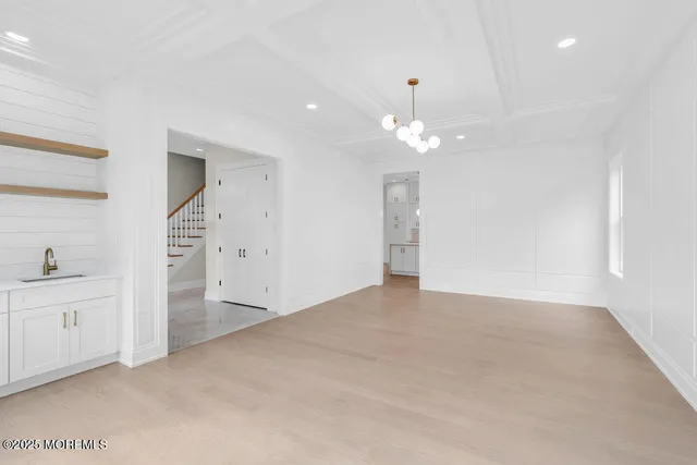 wooden floor in an empty room with a kitchen