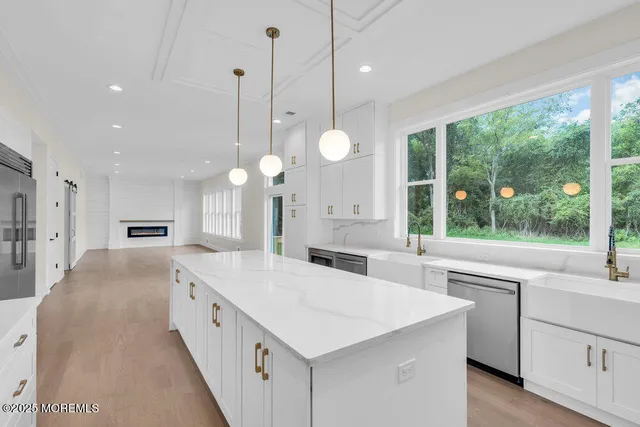 a large white kitchen with a large window