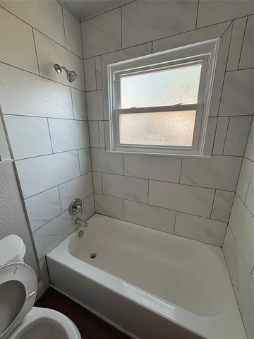 a bath tub sitting next to a white sink