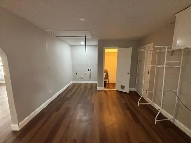 a view of a room with wooden floor and a window