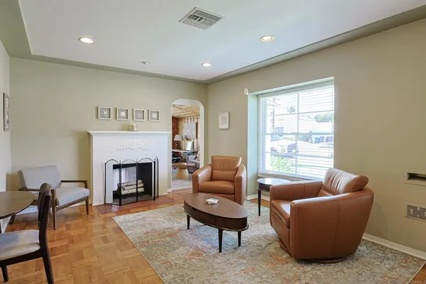 a living room with furniture and a fireplace