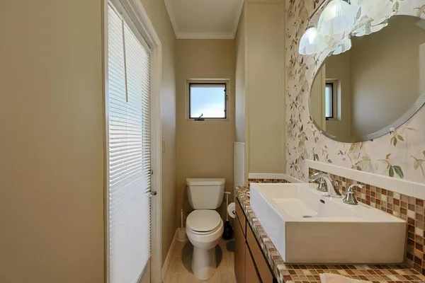 a spacious bathroom with a granite countertop sink a mirror and a bathtub