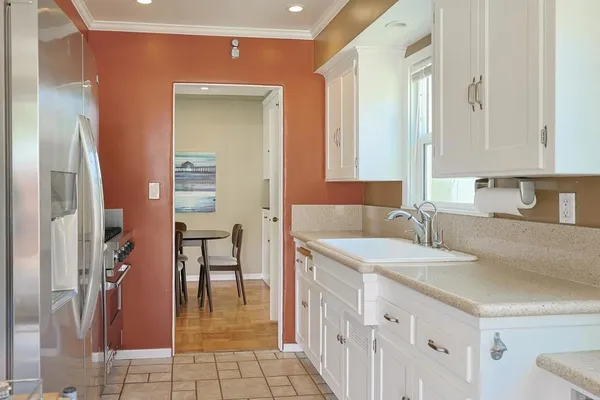 a kitchen with stainless steel appliances granite countertop a refrigerator and a sink