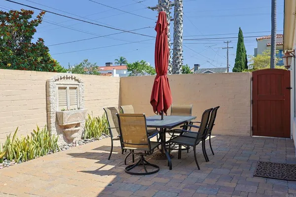 a view of an outdoor dining space with a table and chairs