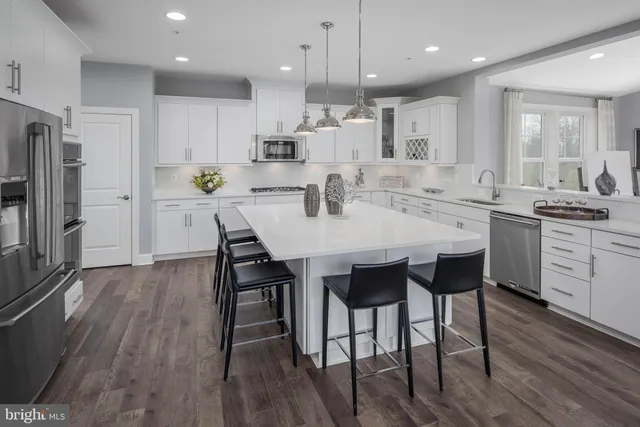 a large kitchen with a table and chairs