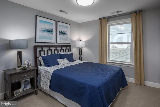 a bedroom with a bed and a lamp on table