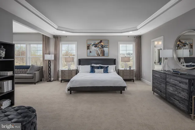 a spacious bedroom with a bed and wooden floor