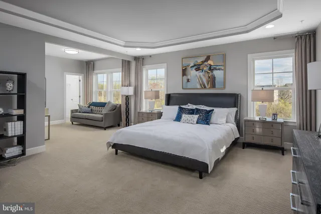 a bedroom with a bed and glass window