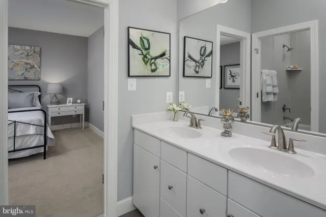 a bathroom with double vanity sink and a mirror