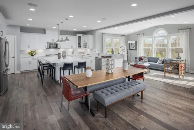 a large dining space with furniture wooden floor and a rug