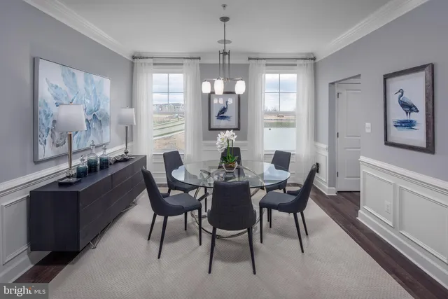 a dining room with furniture a chandelier and wooden floor