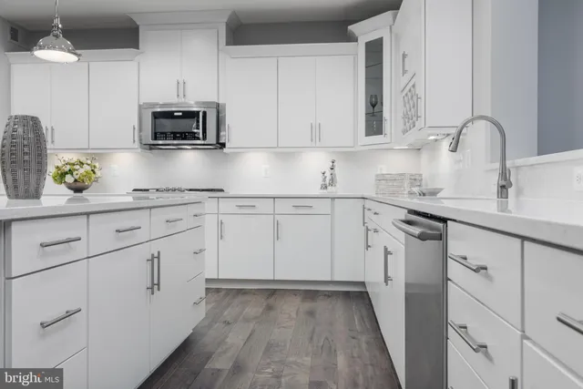 a kitchen with appliances cabinets and a sink